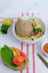 Big bakso or Indonesian meatballs served on the table. It contains meatballs, noodle, and vegetables