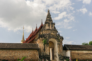 weathered masonry and stucco structure, likely the Viharn or a monumental gateway (Pratu Khong) at...