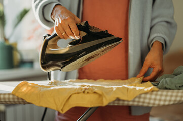Person ironing clothes at home in a comfortable domestic setting