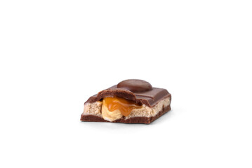 Chocolate bar with caramel, nougat and nuts filling isolated on white background.