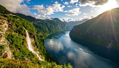 A scenic panoramic view of a fjord with mountains, lush greenery, waterfalls, and the sun's rays bursting through the clouds