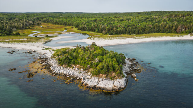 Carter&rsquo;s Beach aerial with winding tidal river and surrounding forest