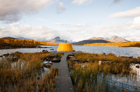 Yellow beacon tower at border intersection of Finland Sweden Norway