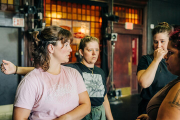 Women having serious discussion, backstage, stained glass window