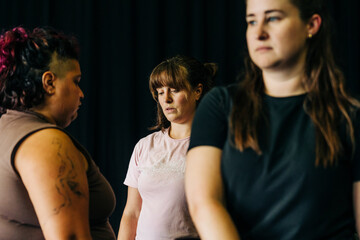 Women group focusing seriously during an indoor rehearsal