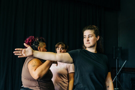 Women rehearsing movement in a dance studio