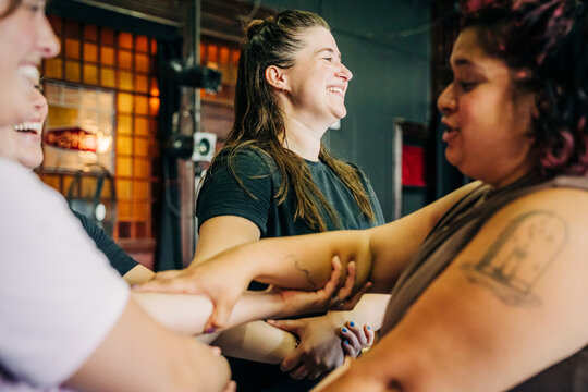 Women group cheering teamwork with arms linked