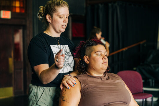Coach instructing woman during a focused workshop