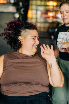 Happy woman laughing with shaved mohawk hairstyle