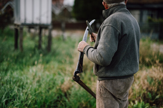 Man working in the field with a tool