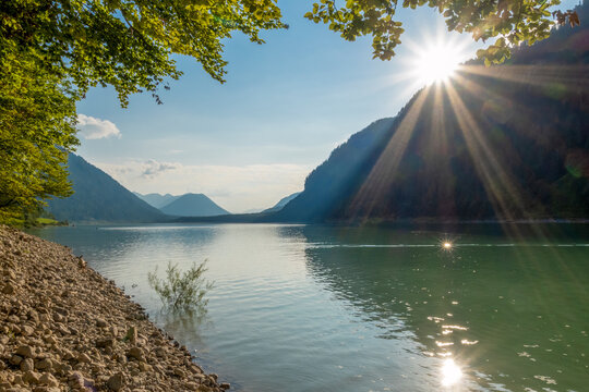 Scenic view of Lake Sylvenstein with sunrays and atmospheric lighting in Bavaria, Germany