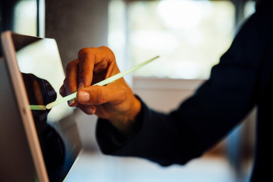 Hand using touchscreen sensor in modern office meeting room