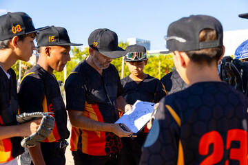 Baseball coach explaining game strategy to youth team