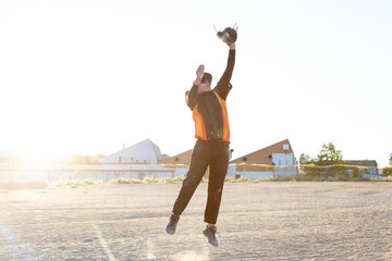 Athlete jumping catching baseball glove outdoors