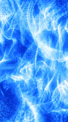 Abstract glowing blue particle waves forming fluid energy motion with a soft luminous texture