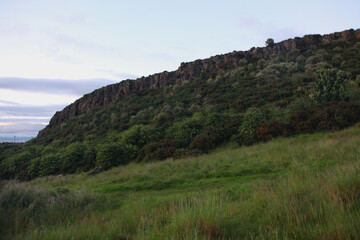 Twilight view of Arthur’s Seat, the iconic Edinburgh hill, overlooking Edinburgh and the surrounding landscape in soft evening light.
