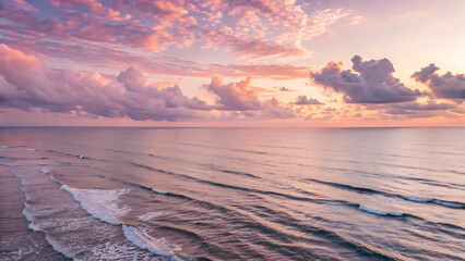 Ocean at sunrise with pink and purple sky, gentle waves