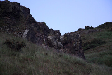 Twilight view of Arthur’s Seat, the iconic Edinburgh hill, overlooking Edinburgh and the surrounding landscape in soft evening light.