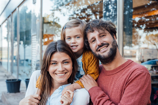 Happy mother and father with daughter