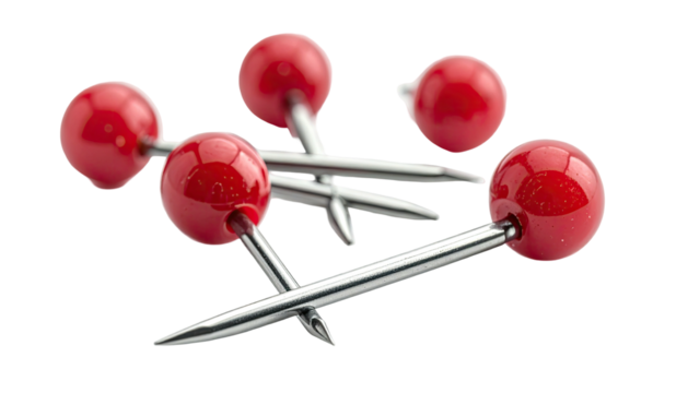 Shiny red push pins scattered on a dark background