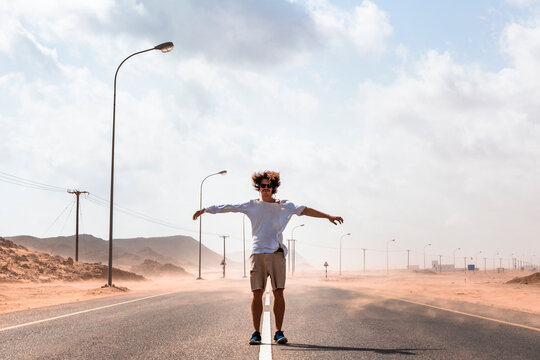 Sultanate Of Oman, Ras al Hadd, Desert road, Man standing in a sand storm