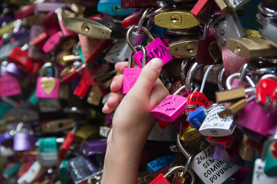 Italy, Veneto, Verona, hand holding a pink love lock