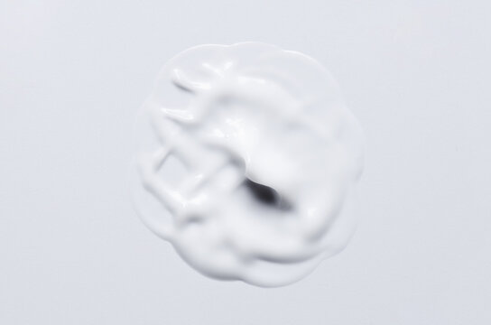 A sample of a white moisturizing cosmetic cream for the body or face with hyaluronic acid