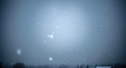 Heavy snowfall against a blurred, serene winter sky creates a magical and tranquil atmosphere over a distant, snow-covered landscape