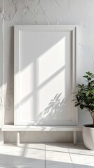 Fototapeta premium Minimalist White Frame Mockup with Sunlight and Plant in a Bright Room.