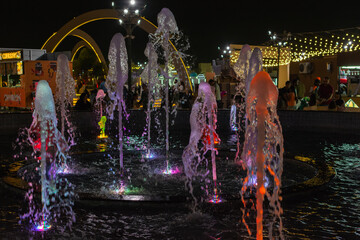 The illuminated musical water fountain attraction at night during the Sheikh Zayed festival 2025-2026 in Al Wathba, Abu Dhabi.