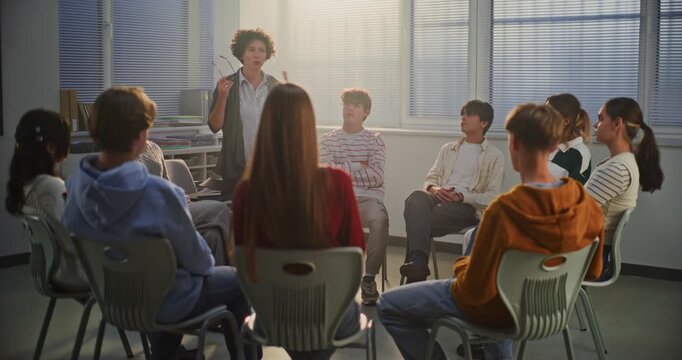 Female Teacher Guides Teenage Girl in Center of Circle Through Emotional Improvisation Exercise, Exploring Real Life Feelings and Empathy. Concept Psychology In Education, Emotional Intelligence.