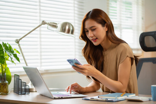 Businesswomen using smartphone payments online shopping at office.