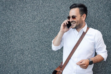 Smiling man talking on phone with sunglasses
