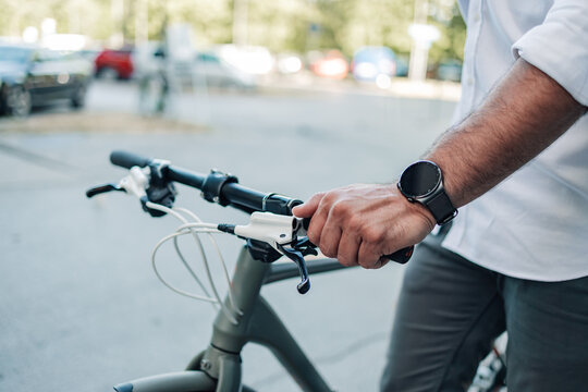 Man cycling a city bike wearing smartwatch