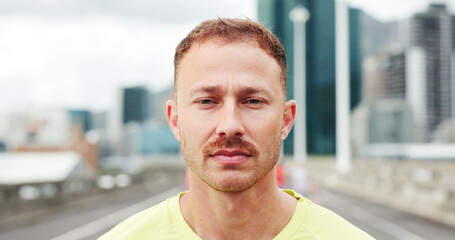 Runner, fitness and portrait of man in city with confidence for exercise, training and wellness in morning. Serious, athlete and person in urban town for sports hobby, challenge and health outdoor