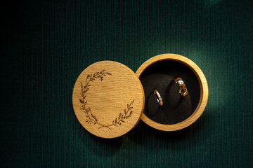 Rustic Wooden Box with Wedding Rings on Green Cord