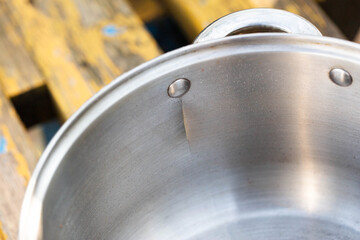 A broken metal pan with a crack, close-up