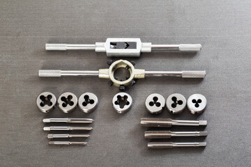 Precision metalworking tap and die set including tap wrenches and various thread cutting tools...