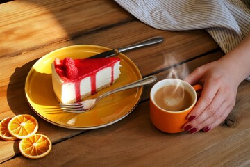 Enjoying a delicious slice of cake with coffee and dried oranges