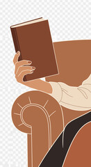 Hand holding a book while sitting in a chair.