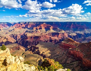 Breathtaking view of vast, layered canyon under a bright blue sky