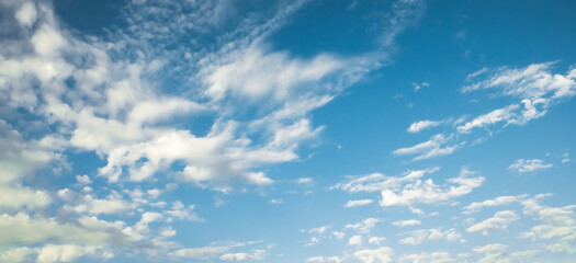 the sky is full of white clouds, bright blue, and beautiful sunlight.