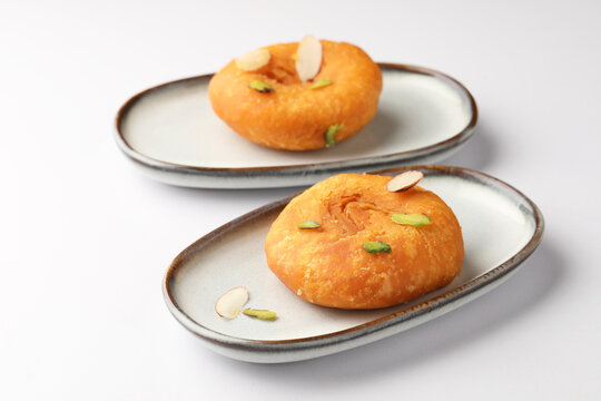 Badusha, famous Indian sweet served in ceramic plates garnish with dry fruits