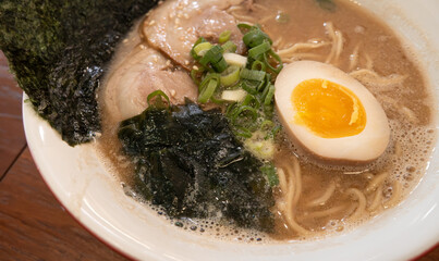 Delicious tonkotsu ramen bowl with delicious char siu above.