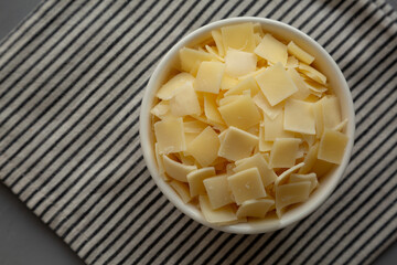 Hard Shaved Parmesan Cheese in a Bowl, top view. Copy space.