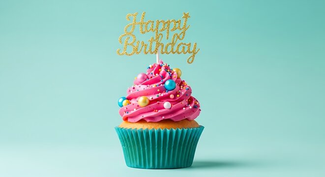 A festive pink frosted cupcake with a gold glitter happy birthday topper
