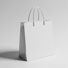A plain white paper shopping bag with twisted handles stands upright on a seamless white background ready for branding or customization isolated on white background