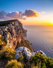 Coastal cliffs under a vibrant sunset sky, over blue ocean