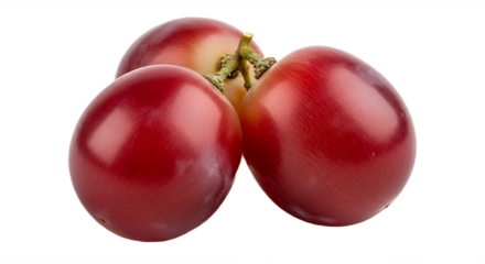 A close up of three red grapes clustered together on a black background in a studio setting