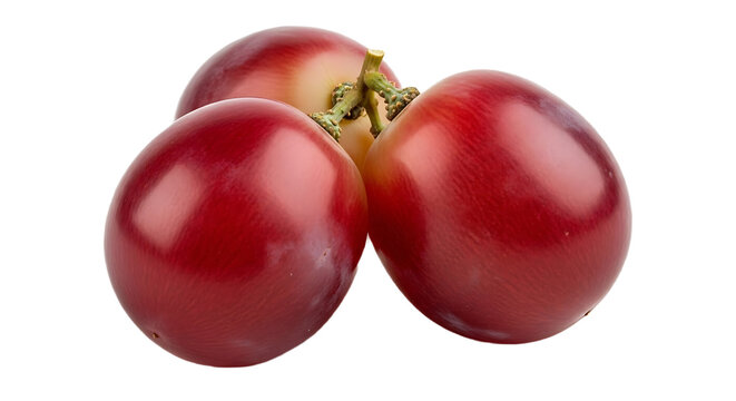 A close up of three red grapes clustered together on a black background in a studio setting